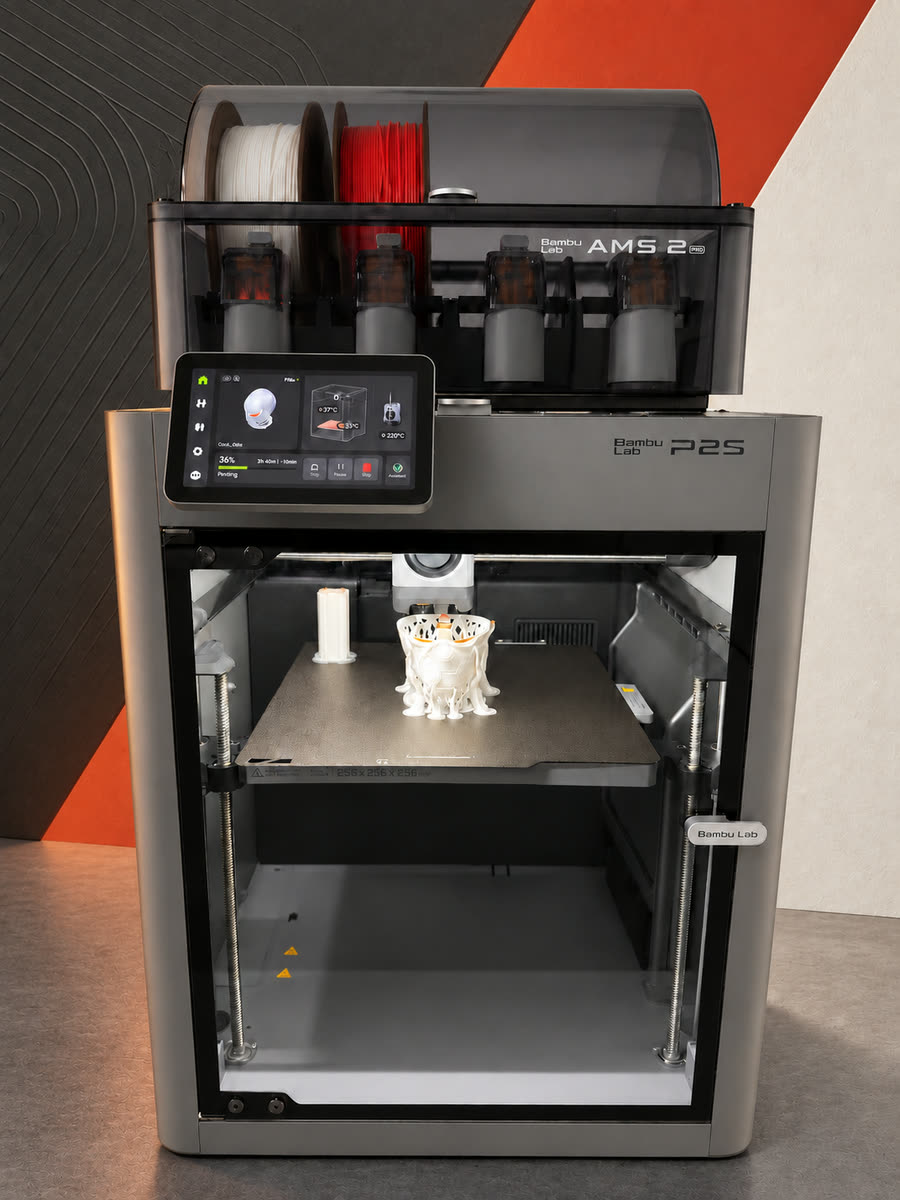 The studio printer mid-job, a white model taking shape on the bed